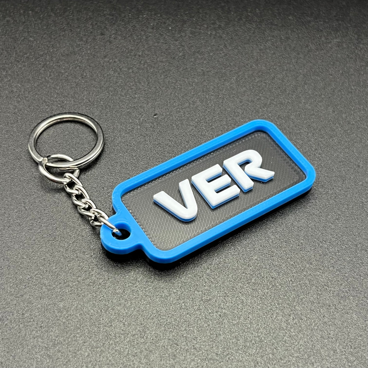 Blue driver code keychain with raised white letters